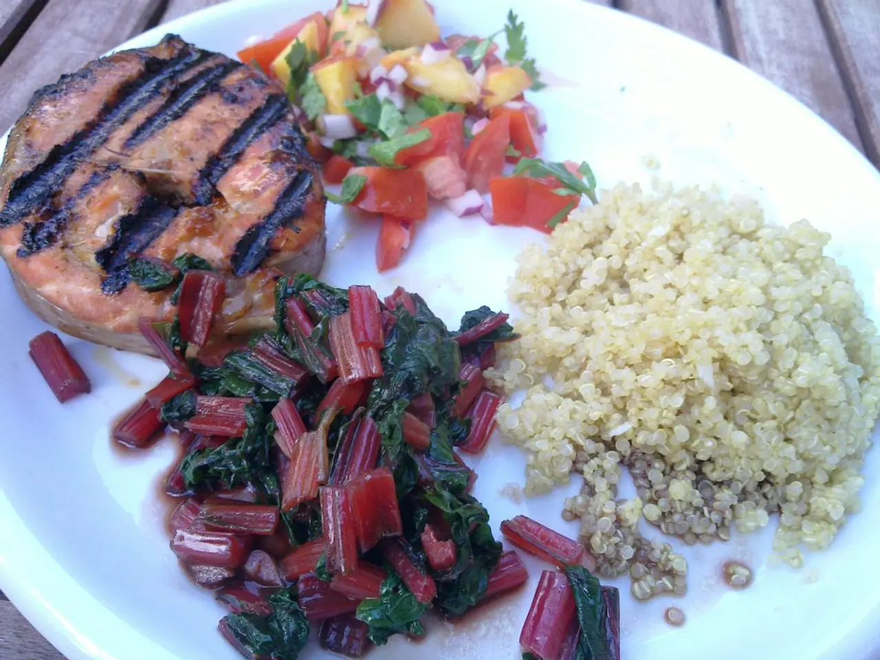 In the image there are some cooked vegetables, salad, a grilled food item and other things served...