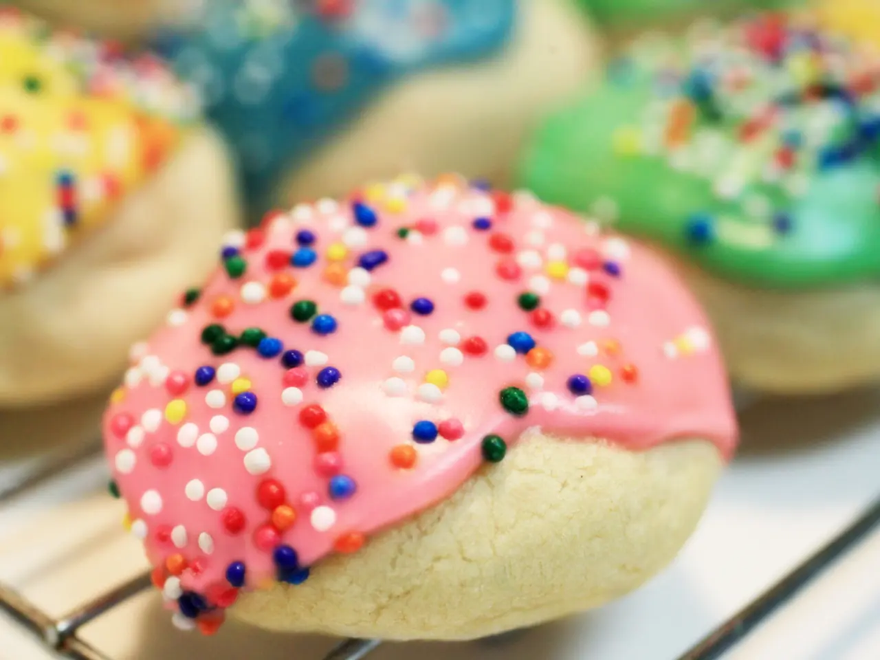 There are food items, decorated with different color creams on the table.