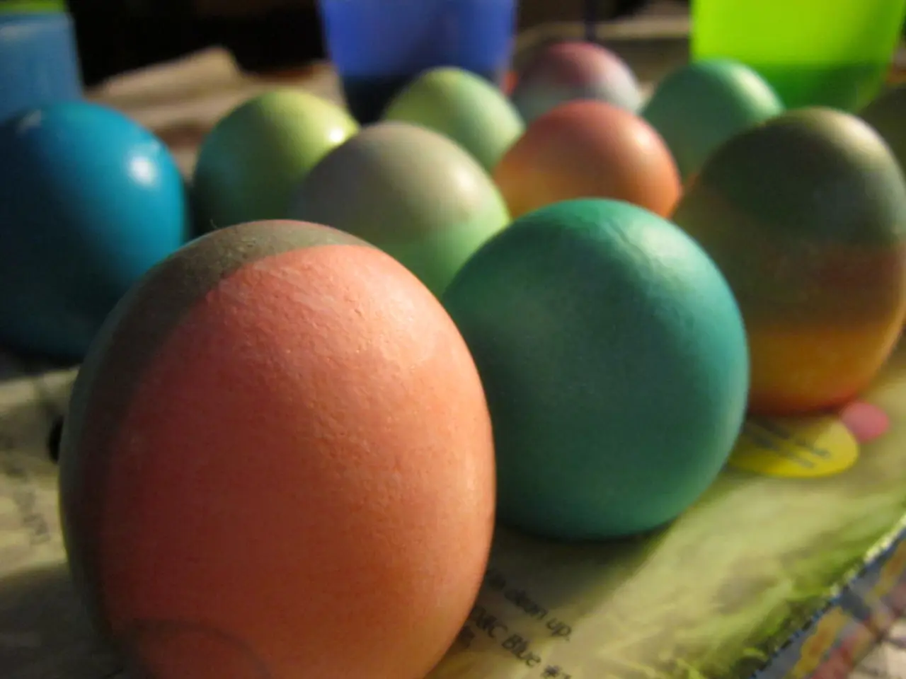 In this image we can see collection of colorful eggs. At the top of the image, we can see colorful...