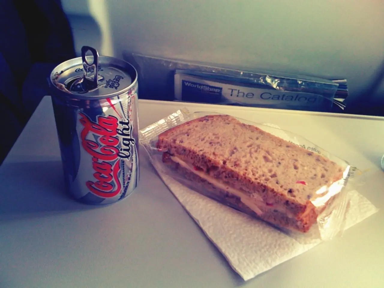In this image we can see some food item which is packed in a cover which is on table and there is...