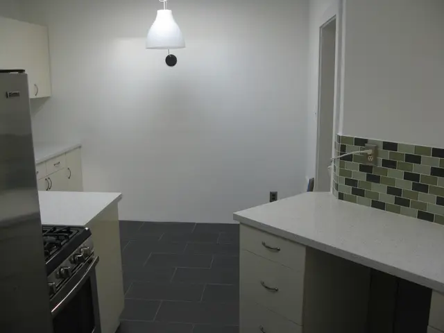 This picture describes about inside view of a room, in this we can find few cupboards, oven, gas...